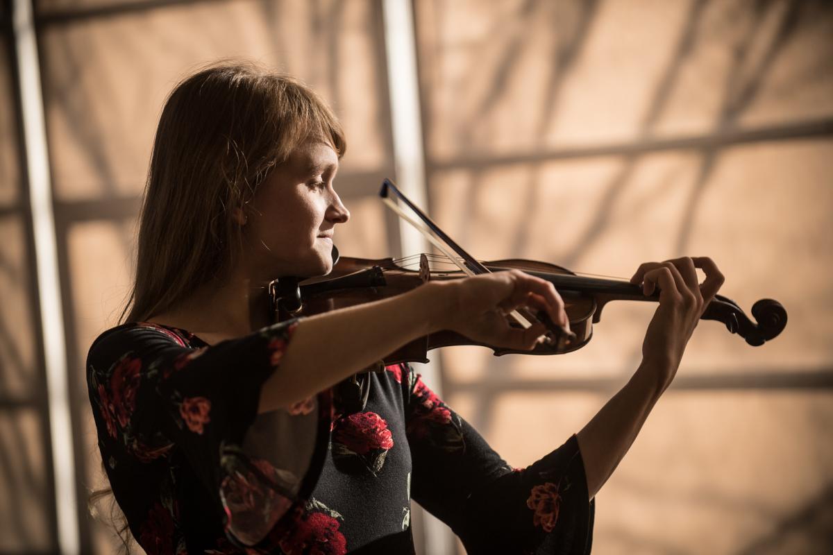 Violin performance by a music education student during ensemble practice.