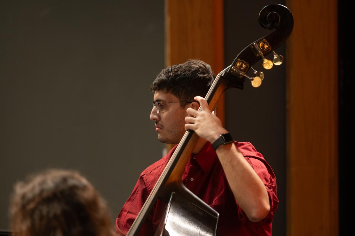 Student holding a musical instrument for Jazz Night.