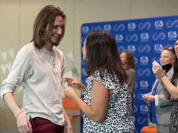 Student and faculty member smiling at Education Department Year-End Reception.