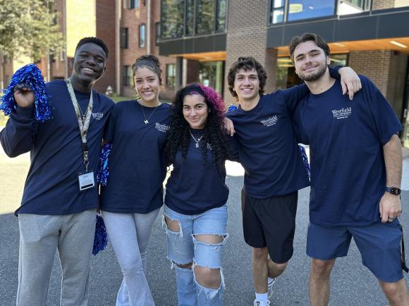 Residential Life student staff smiling together in a group on Move-in Day.