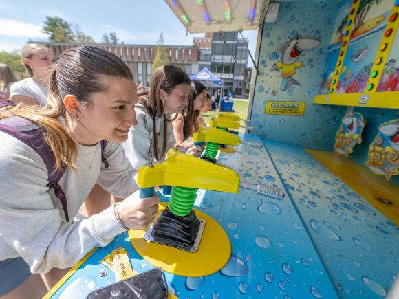 Students at Flight Fest playing a carnival game.