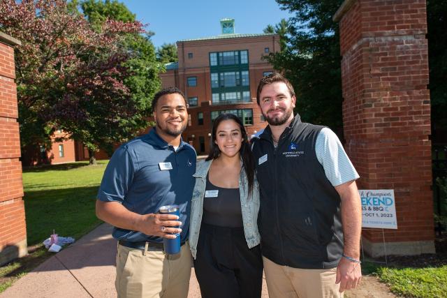 Admissions staff smiling at campus move-in event.