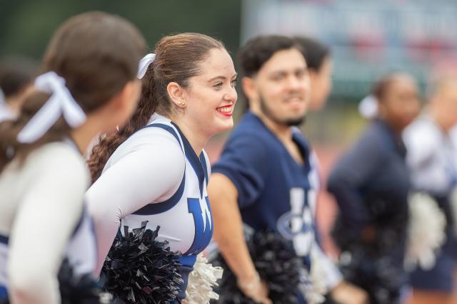 Cheerleader smiling at Family Weekend.