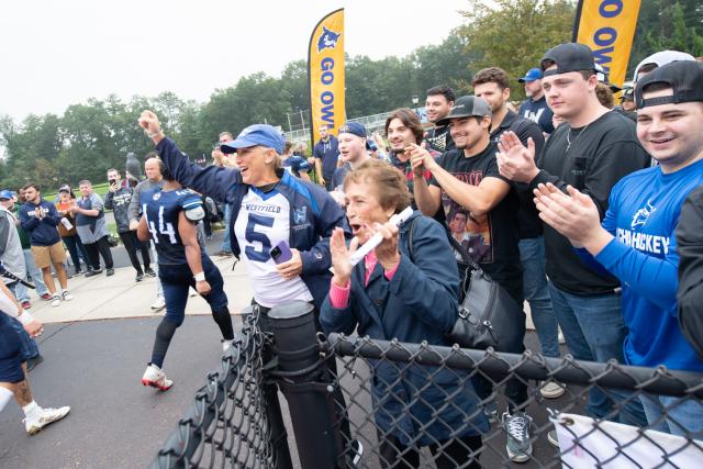 Family Weekend football game showing crowd cheering.