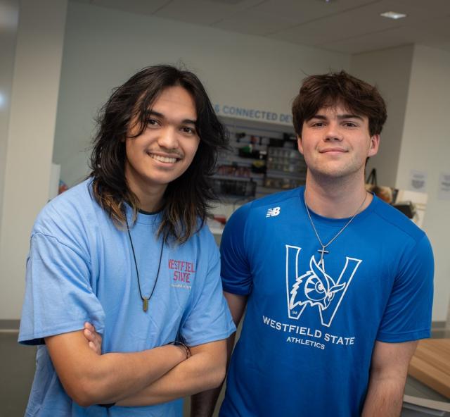 Two students smiling wearing WSU shirts in the RIDE Center.