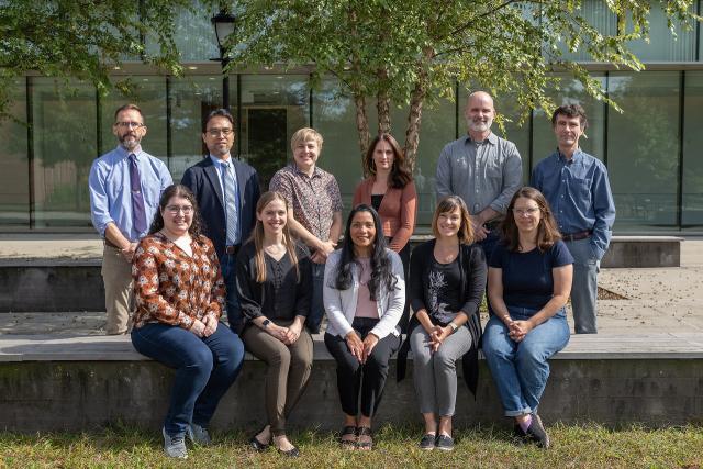 Biology department faculty smiling in a group photo.