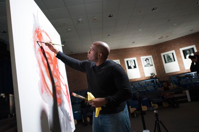 Art professor working on a painting for an exhibit. 