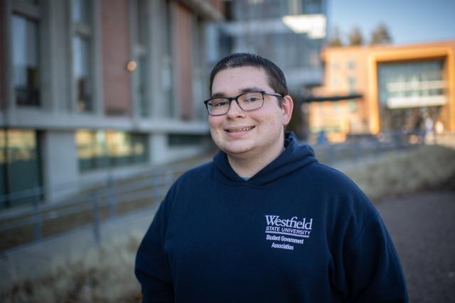 Finance student smiling outside of Ely Campus Center.