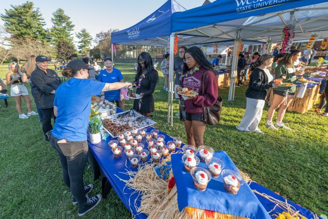 Students enjoying food on the campus green during Welcome Week.