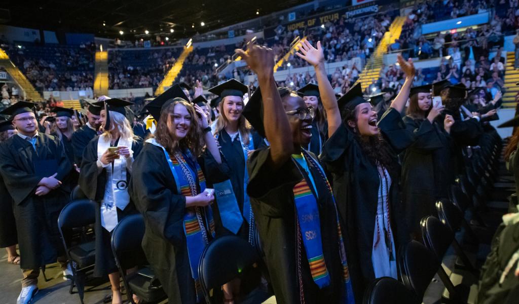 Undergraduate Commencement 2023 at the MassMutual Center featuring students celebrating after receiving their diplomas.