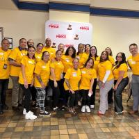 The Western MA Caring Force, all dressed in yellow shirts, posing in Scanlon Hall for the The Western MA Caring Force Rally, held on September 17.